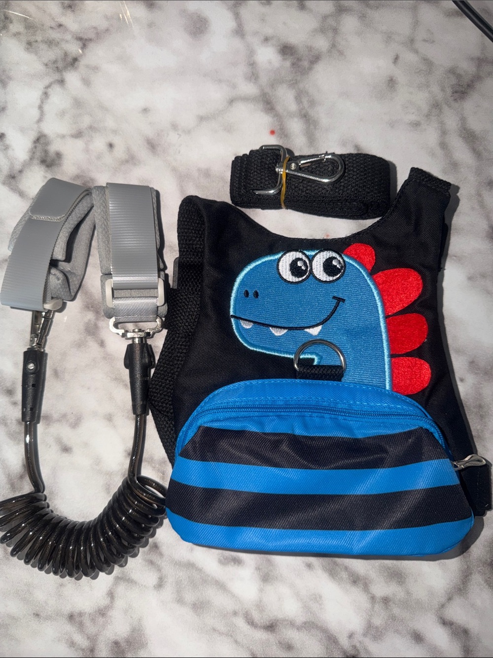 Amazon Kids Dinosaur Safety Harness Backpack in Black, Blue and Red
